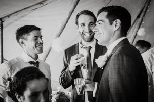 guests chatting with groom