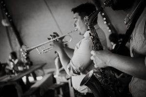 black and white of band palying in tipi