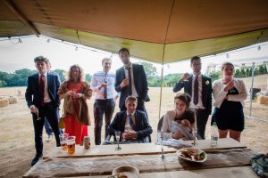 guests listening to speeches at tipi wedding