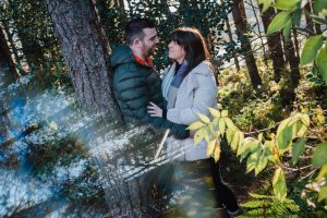 engaged couple in the woods