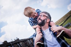 dad and son on shoulders