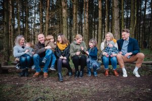 family laughing together sitting on bench