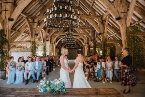 brides with barn in the background