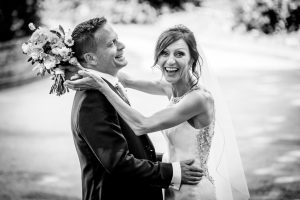bride and groom laughing at camera