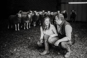 black and white image of couple and sheep