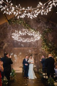 newlywed bride and groom head back down the aisle