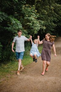 swinging child with family