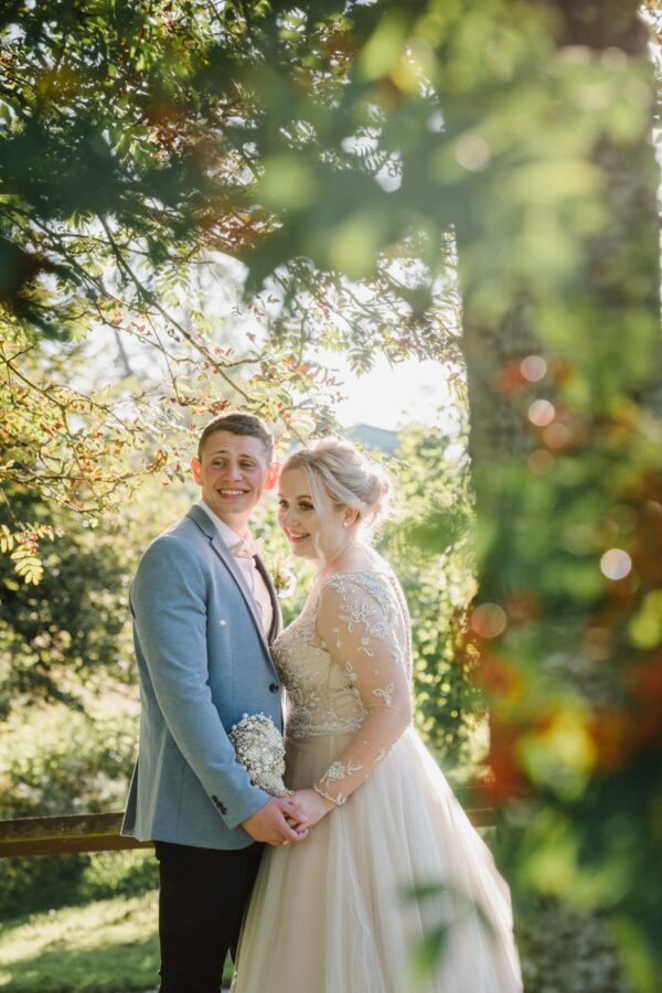 Bride and groom through the trees