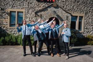 groom and groomsmen strike a pose