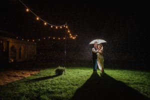 bride and groom in the rain