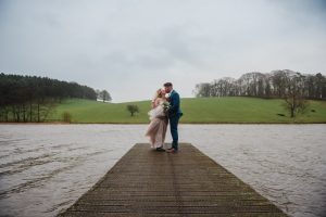 couple kissing on the jetty at Coniston Hotel