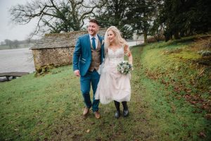 couple newlyweds walking by the lake at Coniston Hotel
