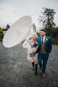 umbrella blows inside out with bridegroom holding