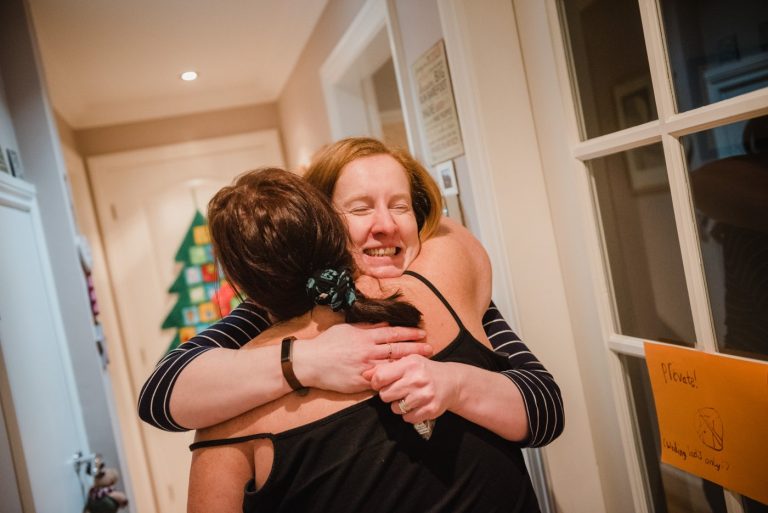 Friend hugs the bride in the morning