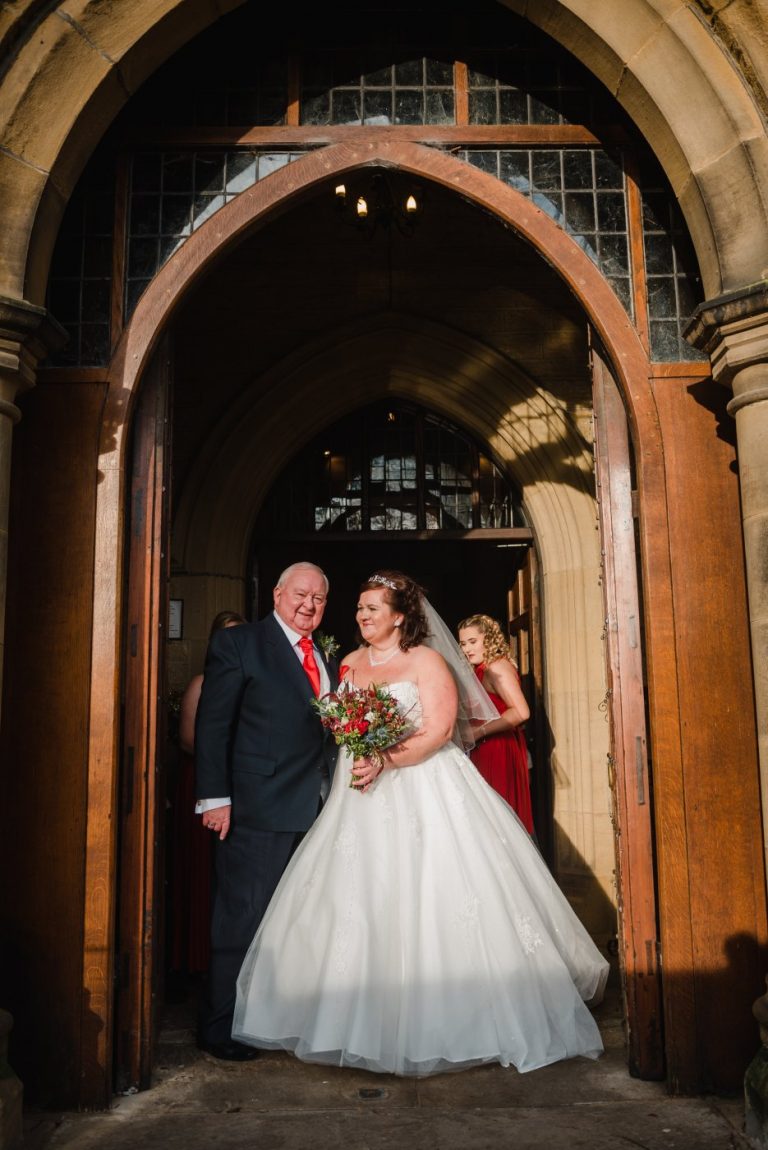 bride and dad in church doorway
