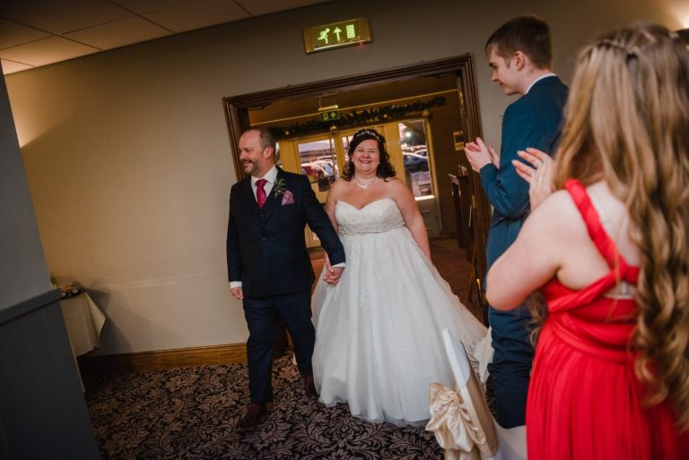bride and groom enter room
