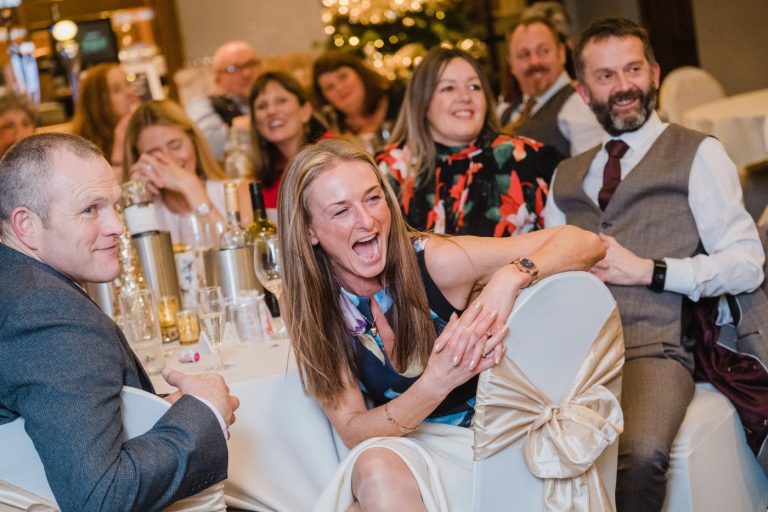 guests laugh at speeches