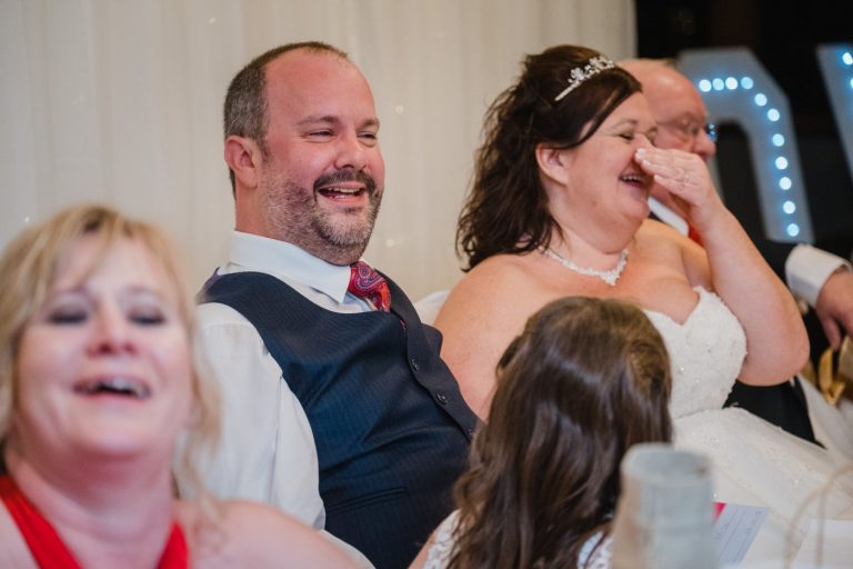 guests laugh at speeches
