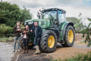 tractor and puppy with brothers and sister
