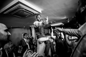 groom is lifted on the dancefloor
