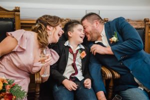 family laughing after wedding