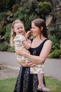 Mum and daughter paying in the park