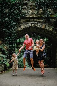 family jumping in the park
