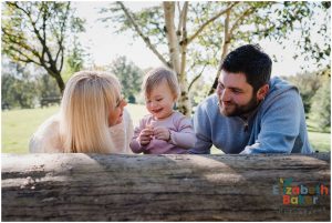 backlit family looking at the leaves