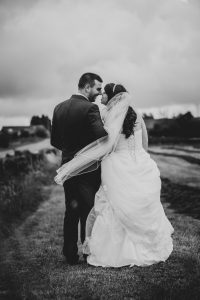 black and white image of newly married couple in field Yorkshire