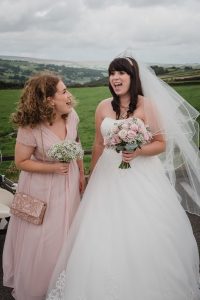 bride and bridesmaid share a laugh before the ceremony at The Fleece
