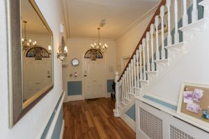 grand hallway with bannister and mirror