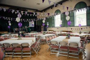 Marsden Mechanics Hall set up for a wedding with purple and white balloons interior shot of main function hall