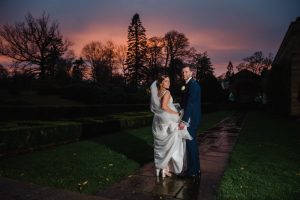 couple with sunset kissing newlyweds