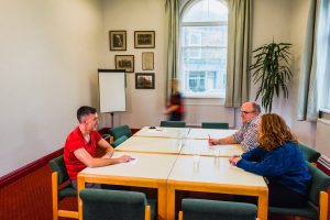 people sitting at meeting table on large table