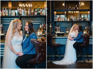 brides cuddle in the coach house bar area