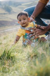 baby plays on grass