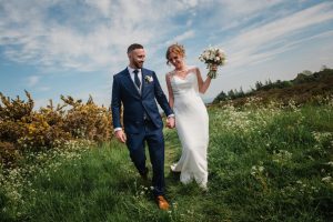 newlyweds walking on the moors above huddersfield