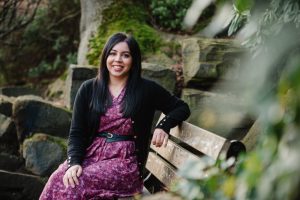 Professional woman sits in an outdoor location