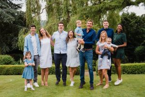 full family photo surrounded by trees