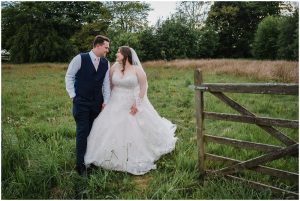 bride and groom walking through a gateway at the huntsman inn