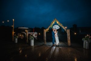 night time shot of newlyweds in the ain