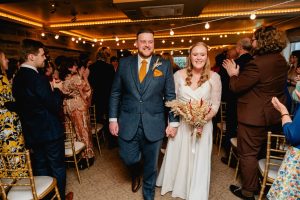 bride and groom walk back down the aisle after the ceremony at whitley hall Sheffield