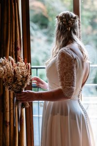 bride standing in the window looking out