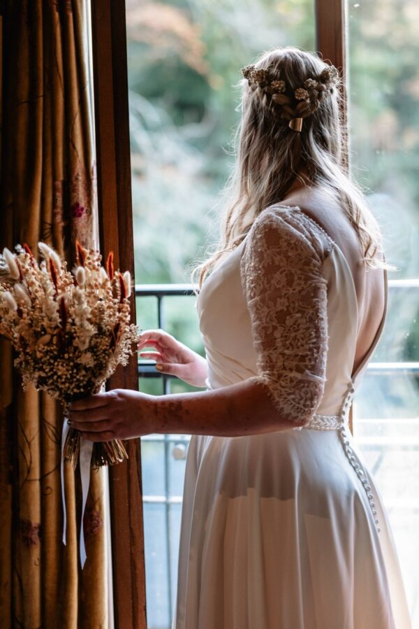 bride standing in the window looking out
