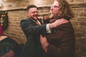 groom and best man having a hug after the speeches