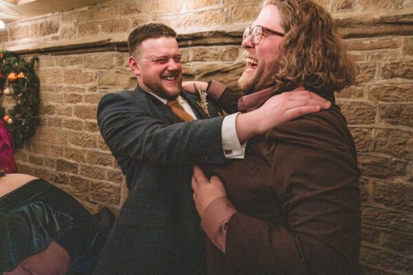 groom and best man having a hug after the speeches