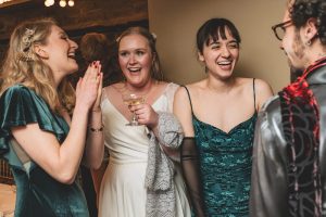 The bride and her friends laughing candid photo