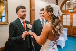 groom gives the bride her wedding ring at Sheffield Town Hall for the wedding