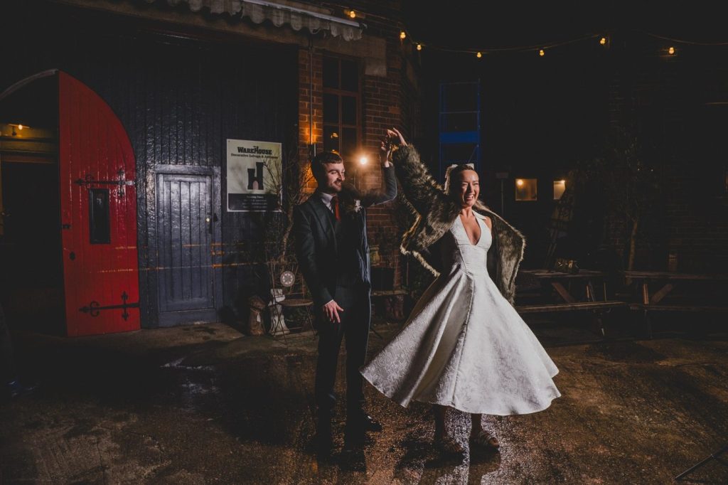 night time photograph of bride and groom dancing outside Yellow Arch Studios in Sheffield
