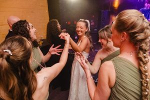party reception after the wedding the bride and her bridesmaids dancing